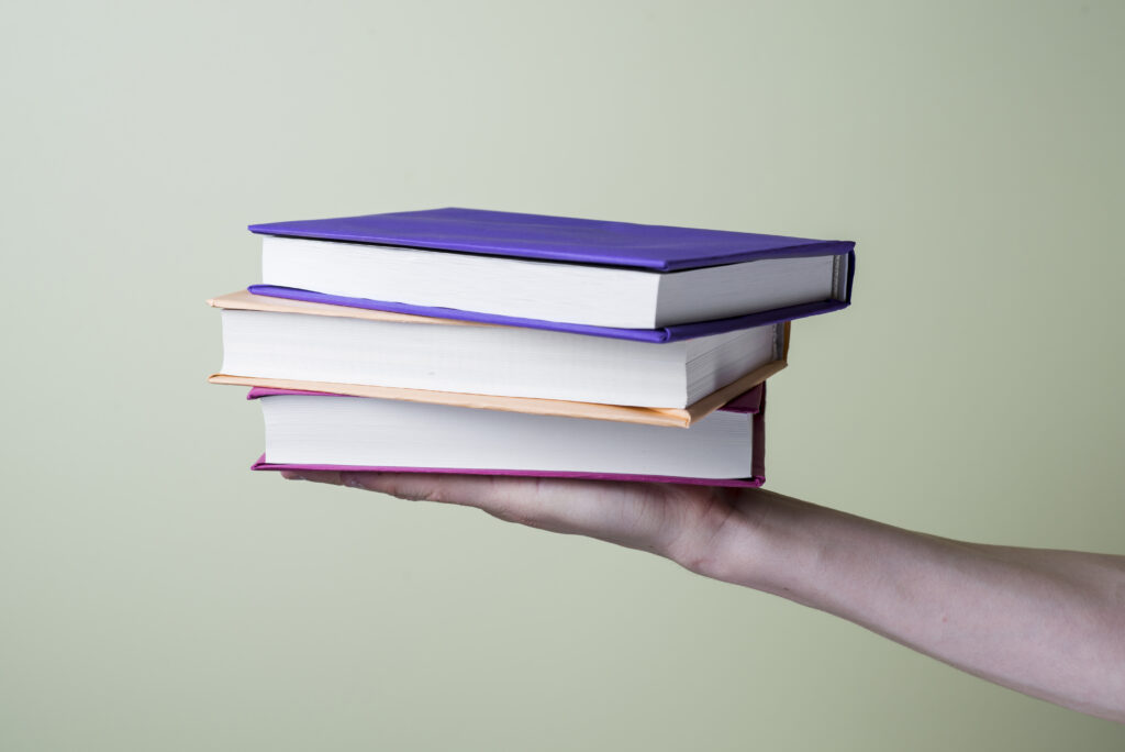 Close Up Hand With Some Books 1024x684